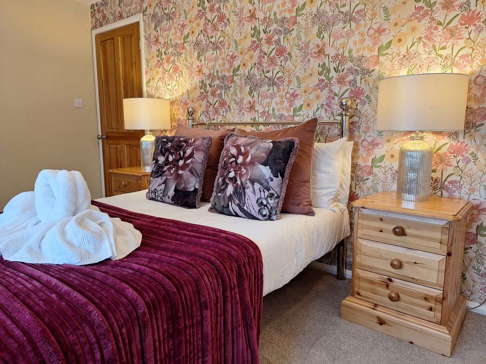 A bedroom with a bed and bedside lamp at Fryers Cottage in Seamer, North Yorkshire