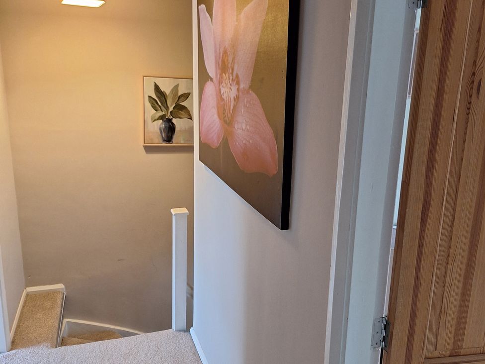 A staircase with a wall painting at Fryers Cottage in Seamer, North Yorkshire