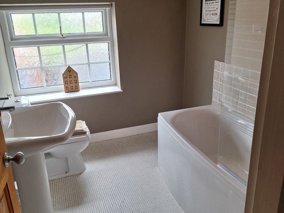 A bathroom with a bathtub and sink at Fryers Cottage in Seamer, North Yorkshire