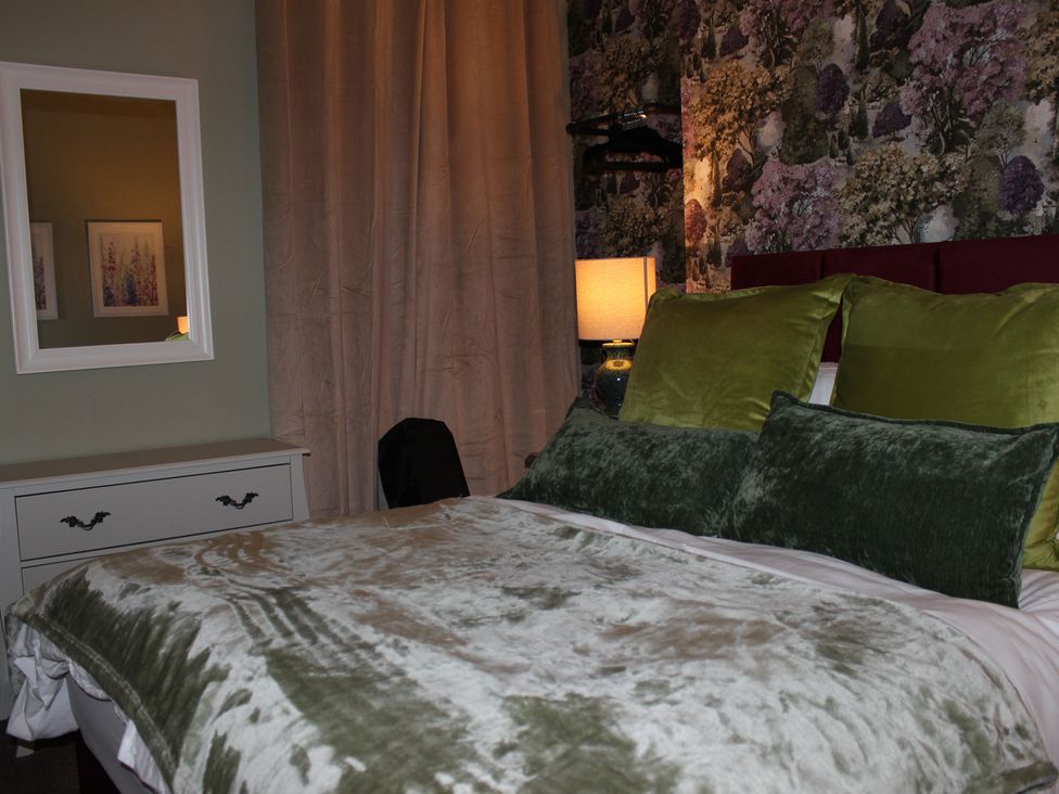 A bedroom with a bed and decorative elements at Blackburn Heights Apartment 1 in Bridlington