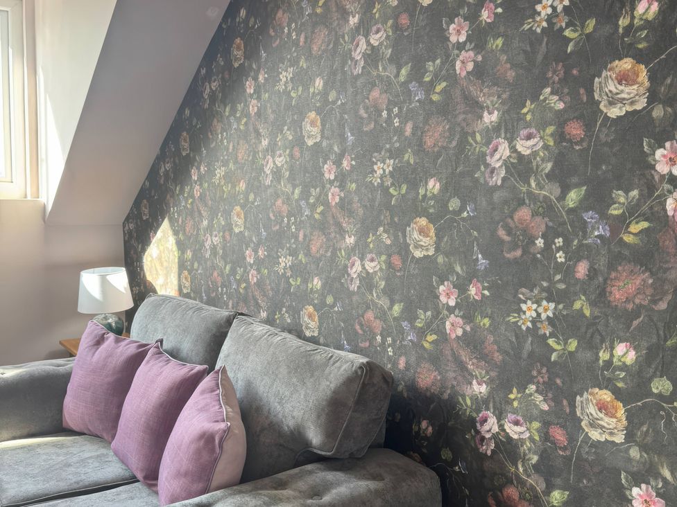 A living room with a sofa and cushions at Blackburn Heights Apartment 3 Bridlington