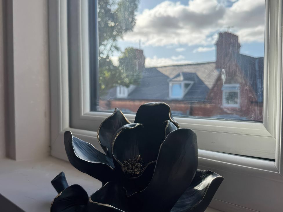 A black flower vase on a windowsill at Blackburn Heights Apartment 3 in Bridlington
