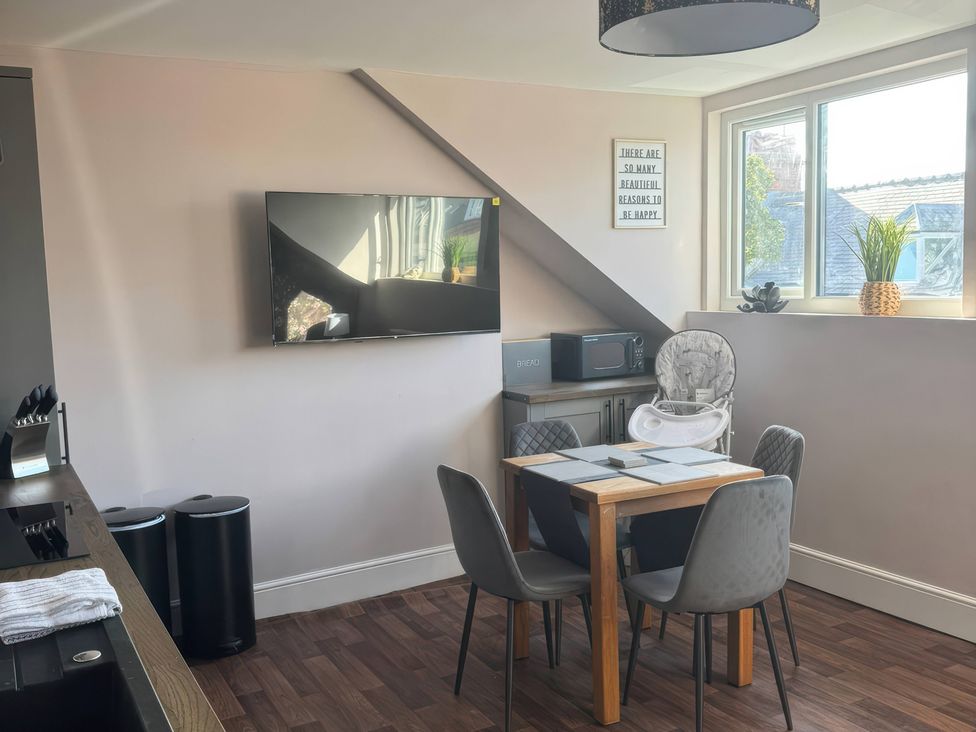 A kitchen with a table and chairs at Blackburn Heights Apartment 3, Bridlington