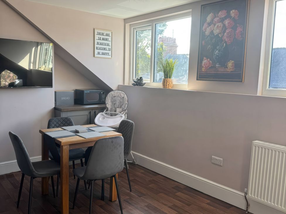A dining area with a table and chairs at Blackburn Heights Apartment 3 Bridlington