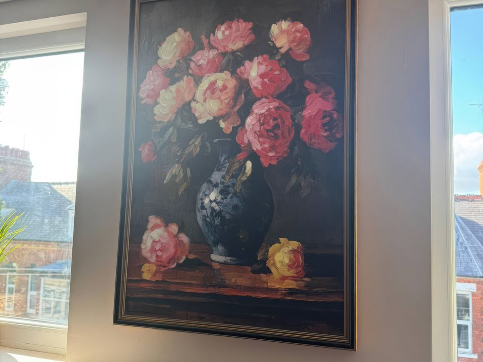 A painting of flowers in a vase on a wall at Blackburn Heights Apartment 3 in Bridlington