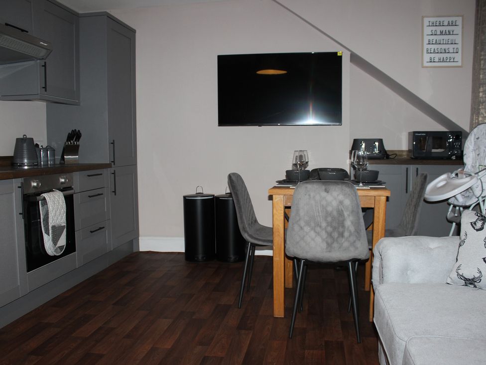 A kitchen with a dining table and chairs at Blackburn Heights Apartment 3 Bridlington