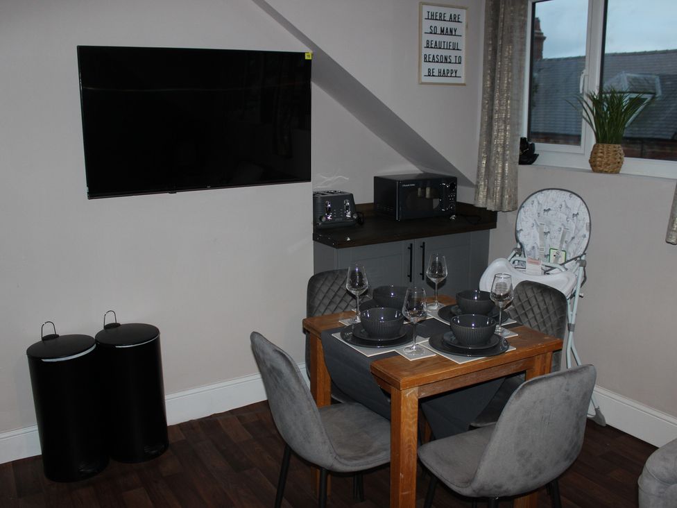 A dining area with a table set for meal at Blackburn Heights Apartment 3 in Bridlington