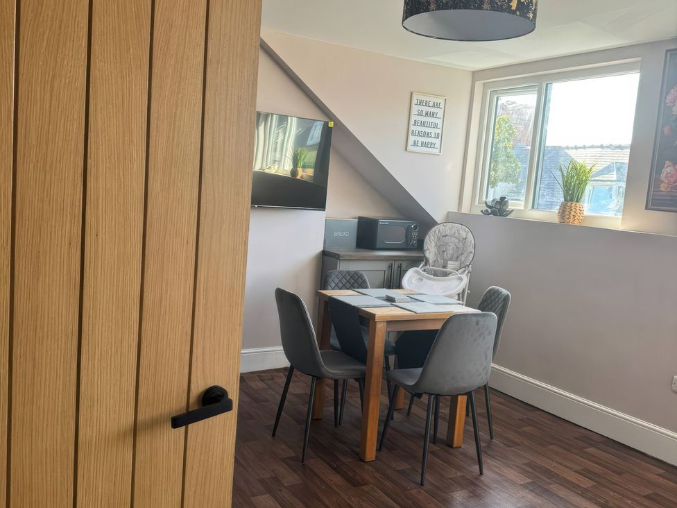 A dining room with a table and chairs at Blackburn Heights Apartment 3 in Bridlington