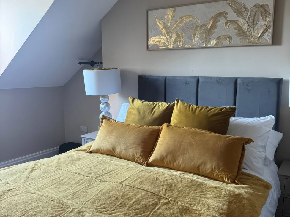 A bedroom with a bed and wall art at Blackburn Heights Apartment 3 in Bridlington