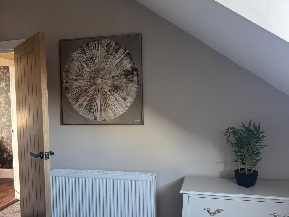 An interior room with wall art and a plant at Blackburn Heights Apartment 3 in Bridlington