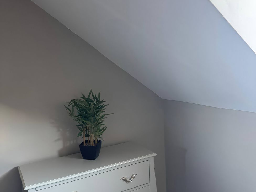 A bedroom with a plant on a dresser at Blackburn Heights Apartment 3 in Bridlington