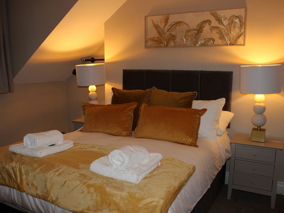 A bedroom with a bed and bedside table at Blackburn Heights Apartment 3 in Bridlington