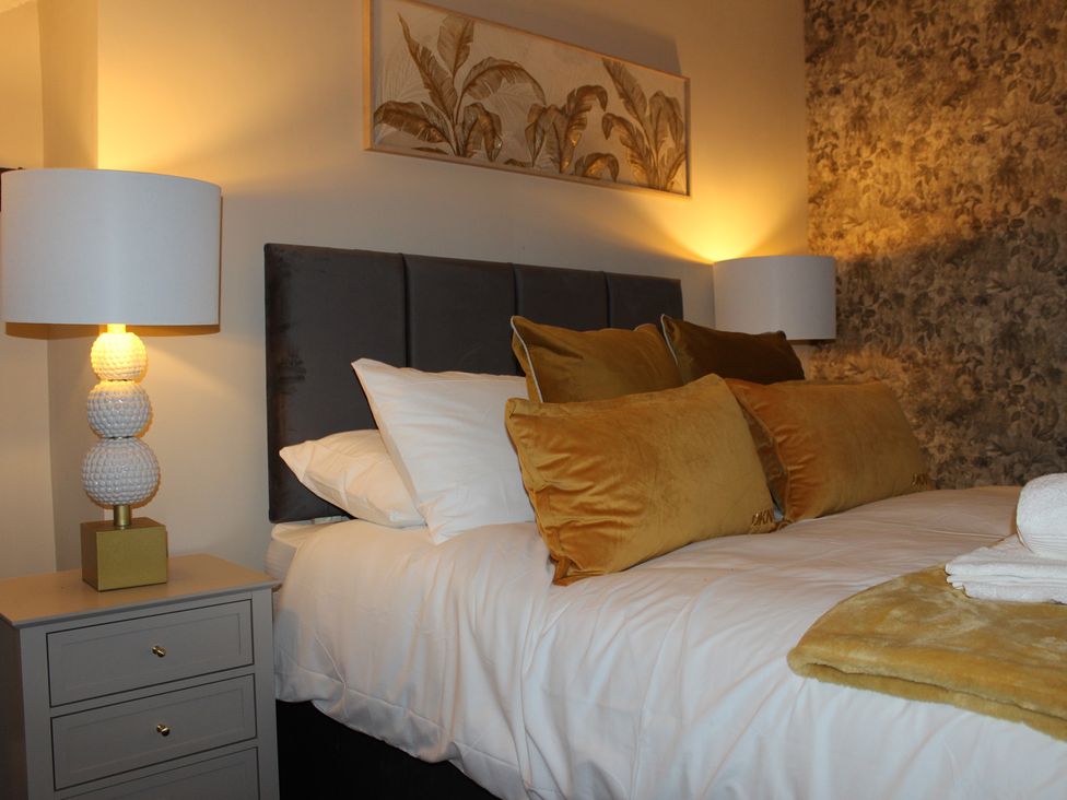 A bedroom with a bed and bedside table at Blackburn Heights Apartment 3 Bridlington