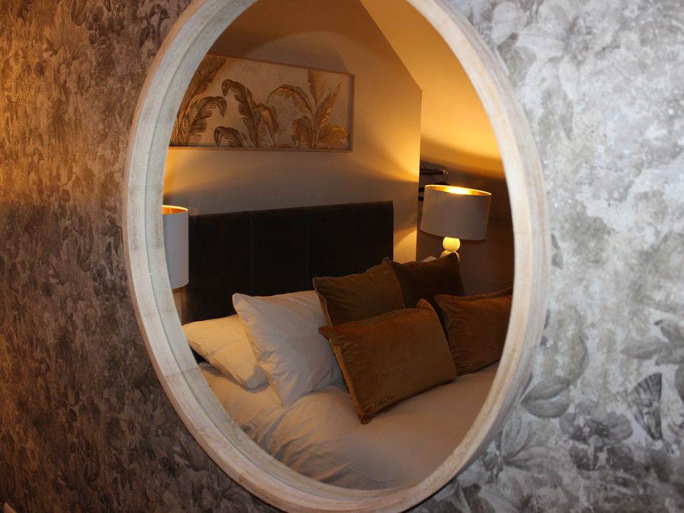 A bedroom with a bed and bedside lamp at Blackburn Heights Apartment 3 in Bridlington