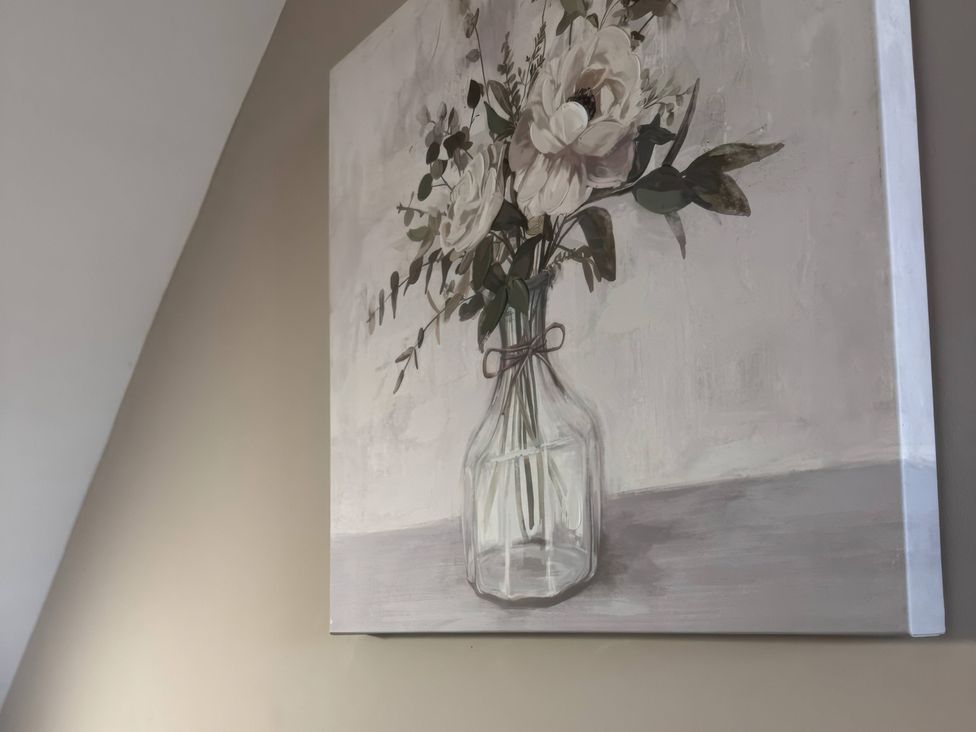 A painting of flowers in a glass vase at Blackburn Heights Apartment 3, Bridlington