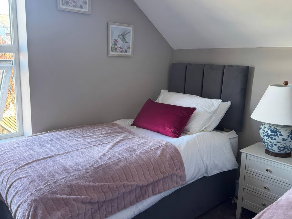 A bedroom with a single bed and nightstand at Blackburn Heights Apartment 3 in Bridlington