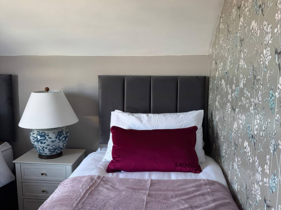 A bedroom with a bed and bedside table at Blackburn Heights Apartment 3 in Bridlington