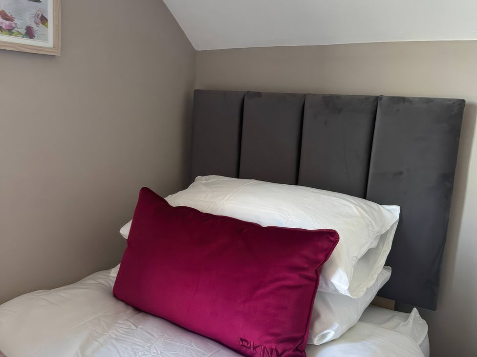A bedroom with a bed and pillows at Blackburn Heights Apartment 3 in Bridlington