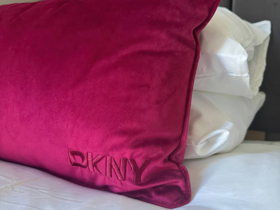 A pink pillow on a bed at Blackburn Heights Apartment 3 in Bridlington