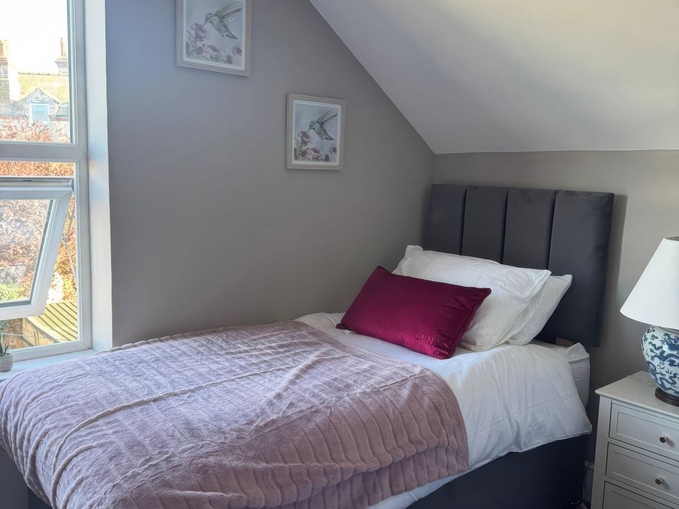 A bedroom with a bed and window at Blackburn Heights Apartment 3 in Bridlington