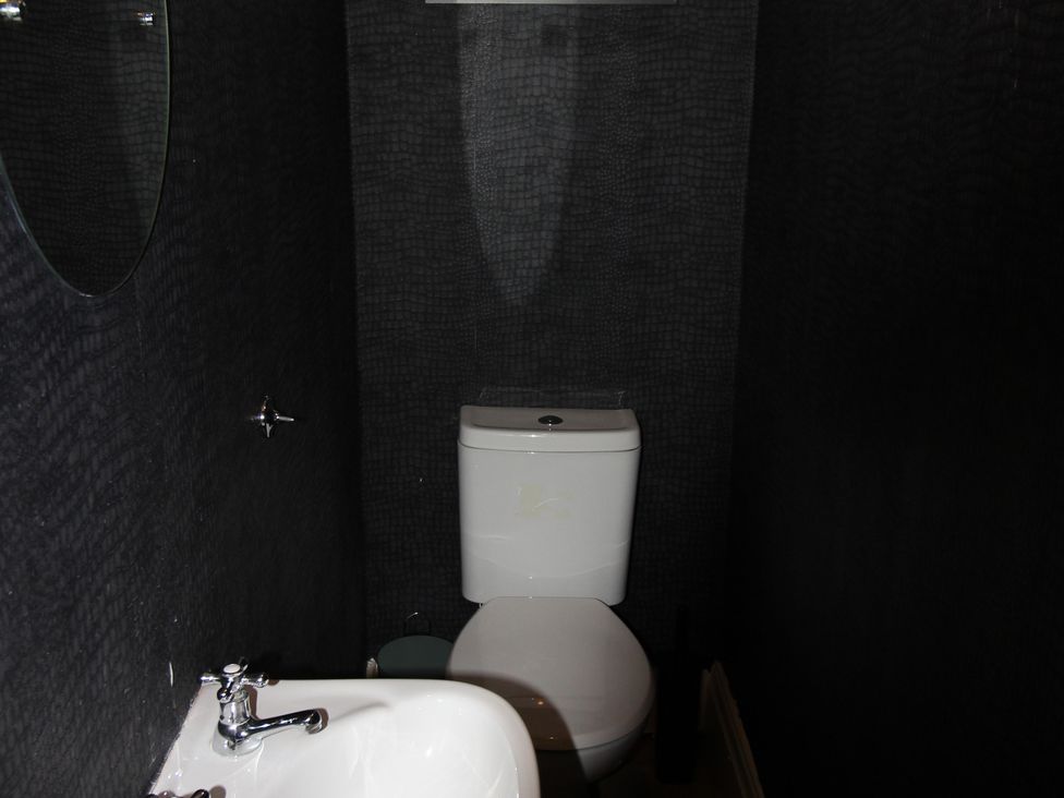 A bathroom with a toilet and sink at Cornerhouse Apartment 1 in Llandudno