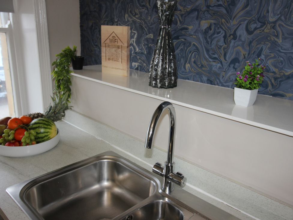 A kitchen with a sink and fruit bowl at Cornerhouse Apartment 2 in Llandudno
