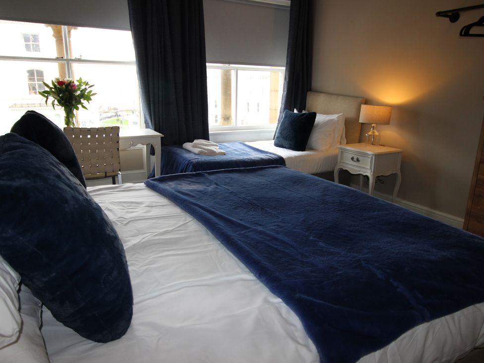 A bedroom with a double bed and a single bed at Cornerhouse Apartment 2, Llandudno