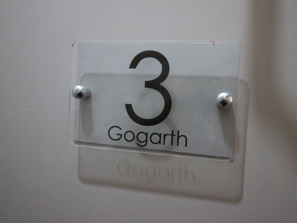 A nameplate displaying the number 3 and the name Gogarth at Cornerhouse Apartment 3 Llandudno