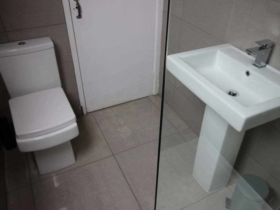 A bathroom with a toilet and a sink at Cornerhouse Apartment 4 Llandudno