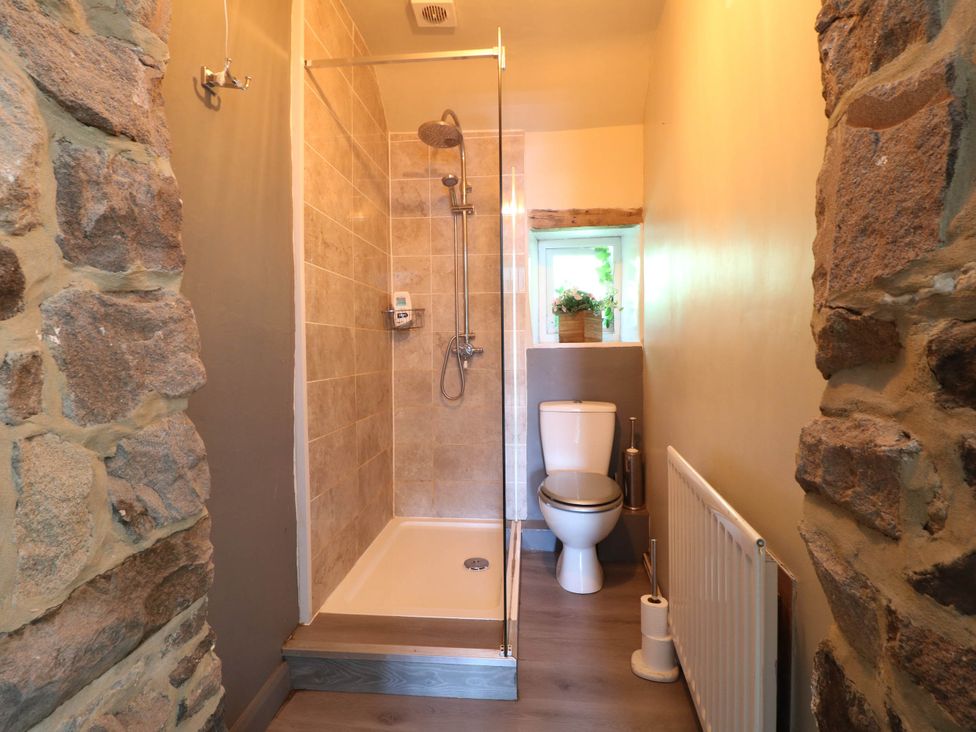 A bathroom with a shower and toilet at Jasmine Cottage in Matlock