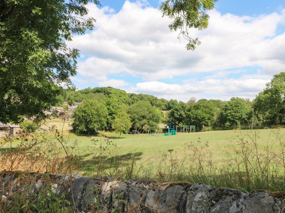 A field with a playground and trees at Jasmine Cottage in Matlock