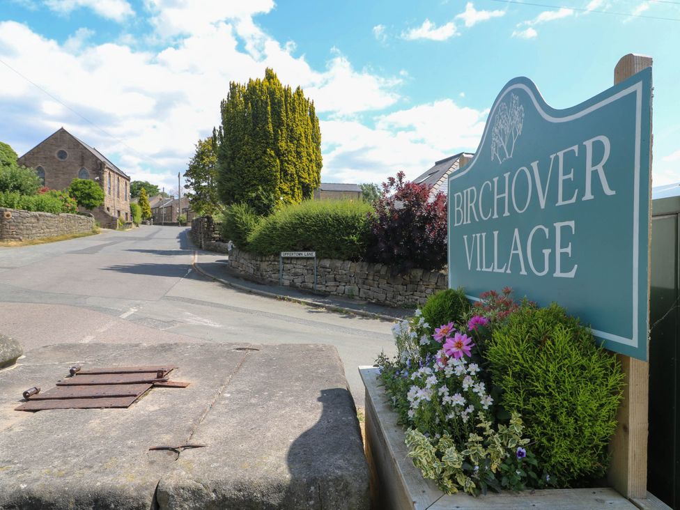 A sign for Birchover Village beside a road at Jasmine Cottage in Matlock