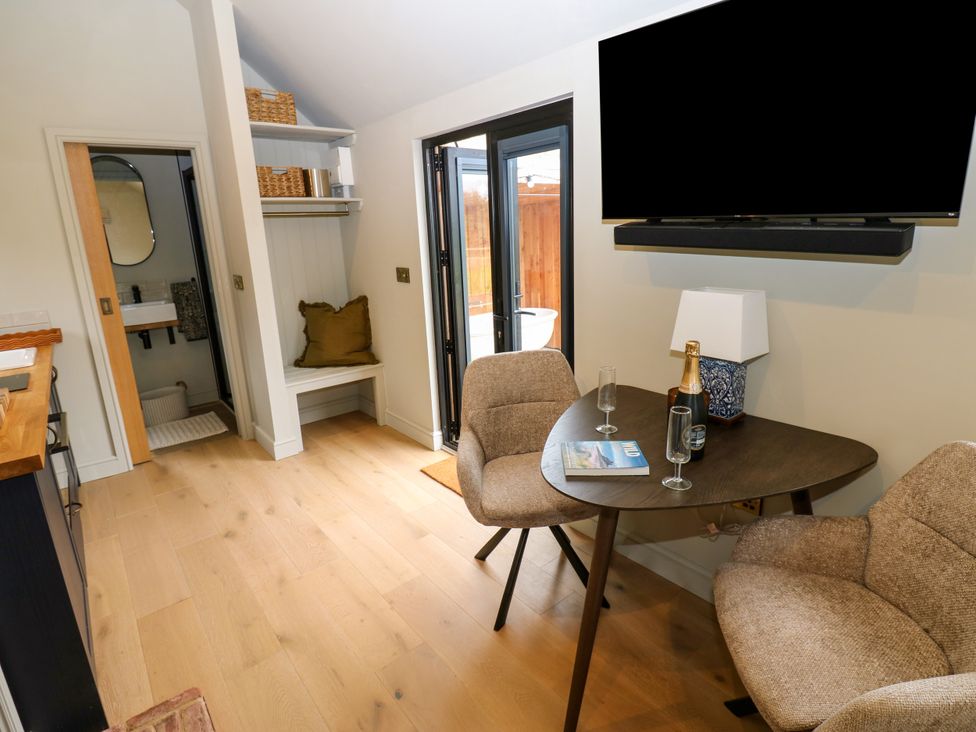 A dining area with a table and armchairs at 2 West Dunkirk Neuk in Hexham