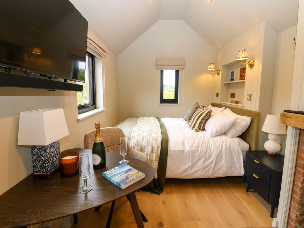 A bedroom with bed and television at 2 West Dunkirk Neuk in Hexham