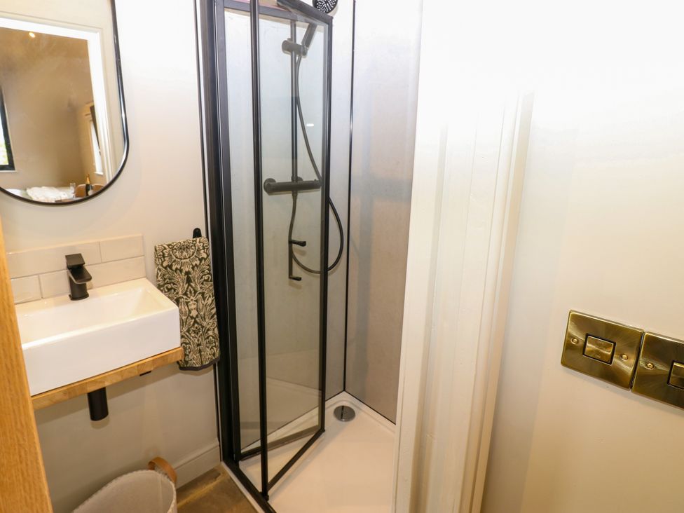 A bathroom with a shower and sink at 2 West Dunkirk Neuk Hexham