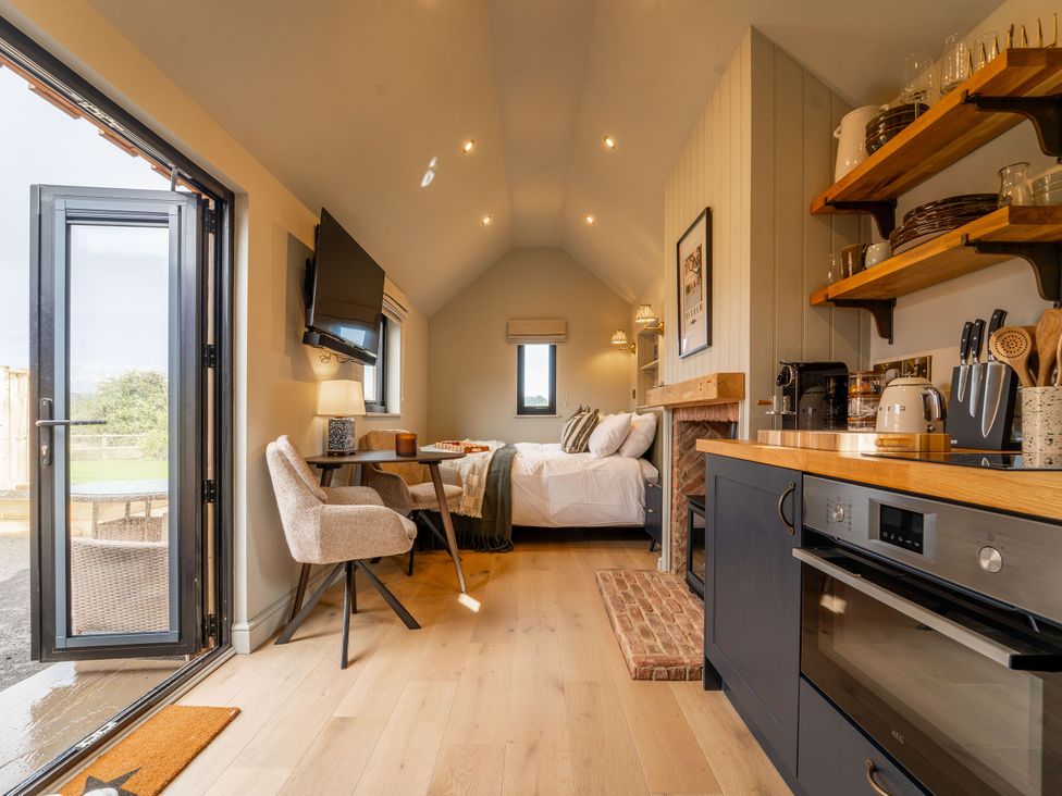 A studio room with a bed, kitchen area, and dining table at 2 West Dunkirk Neuk Humshaugh