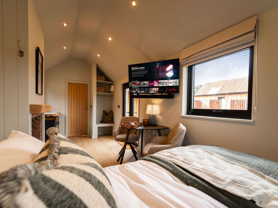 A bedroom with a bed and TV at 2 West Dunkirk Neuk in Humshaugh