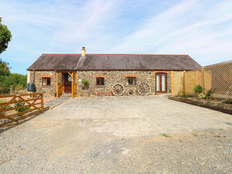 A house with wheels and a fence at Coedllys Uchaf Cottage