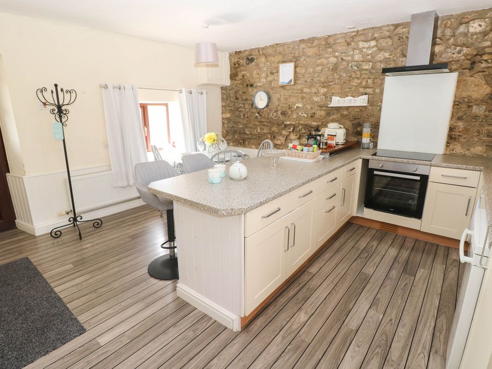 A kitchen with countertops and appliances at Coedllys Uchaf Cottage