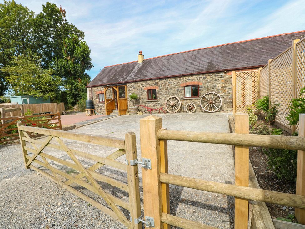 A farmhouse with a gate and garden at Coedllys Uchaf Cottage in 
