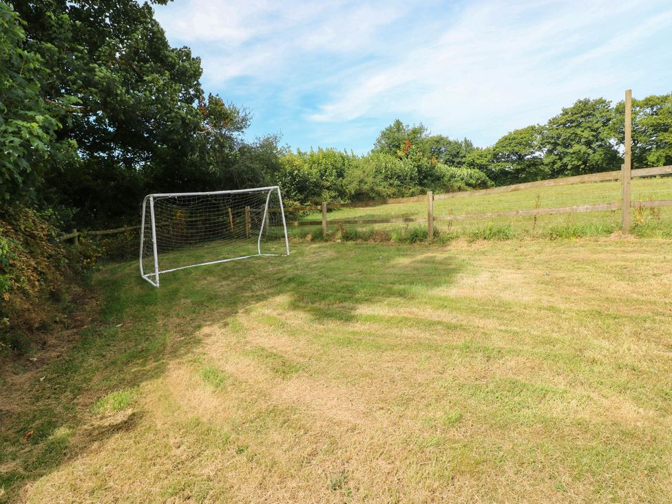An outdoor area with a goal post and a fence at Coedllys Uchaf Cottage