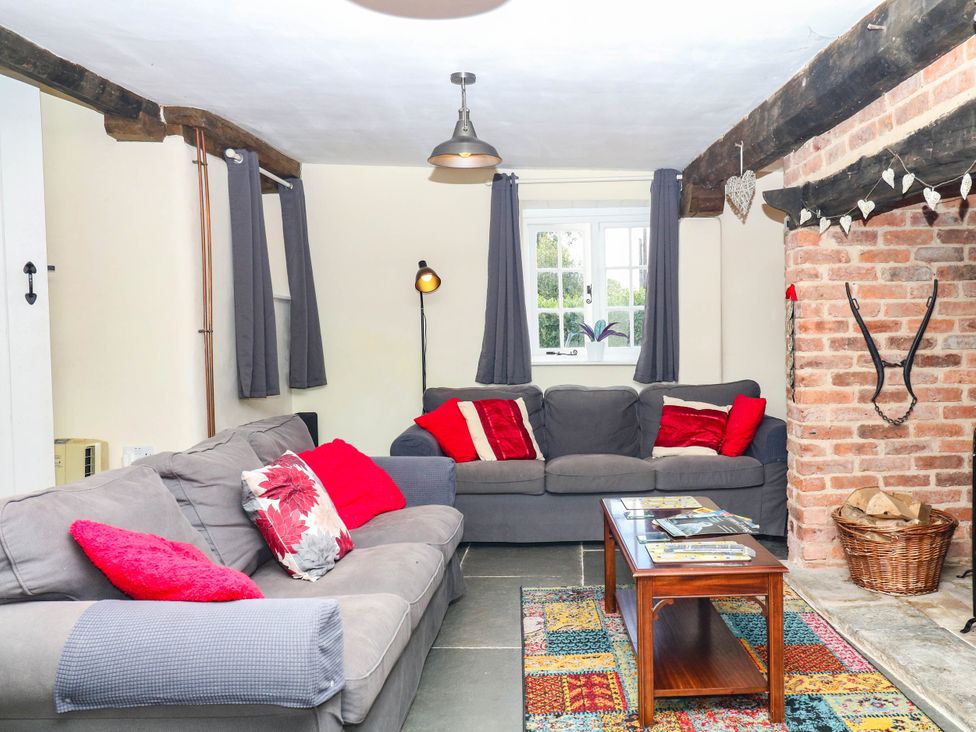 A living room with sofas and a table at The Cheese House near Charmouth