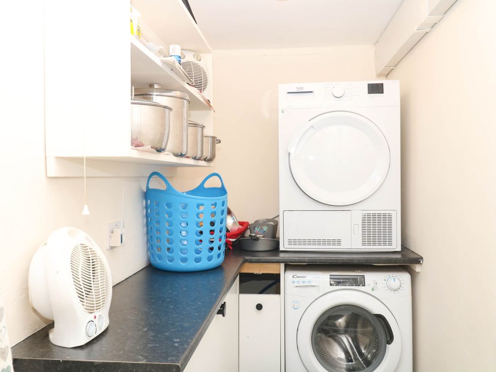 A laundry room with a washing machine and tumble dryer at The Cheese House near Charmouth