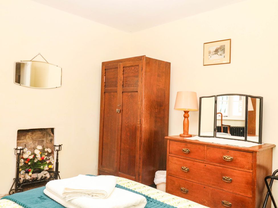 A bedroom with a wardrobe and dressing table at The Cheese House near Charmouth