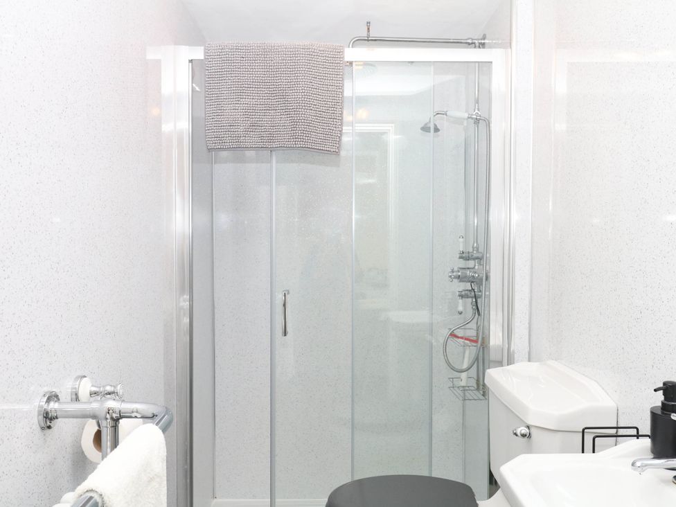 A bathroom with a shower, toilet, and sink at The Cheese House near Charmouth
