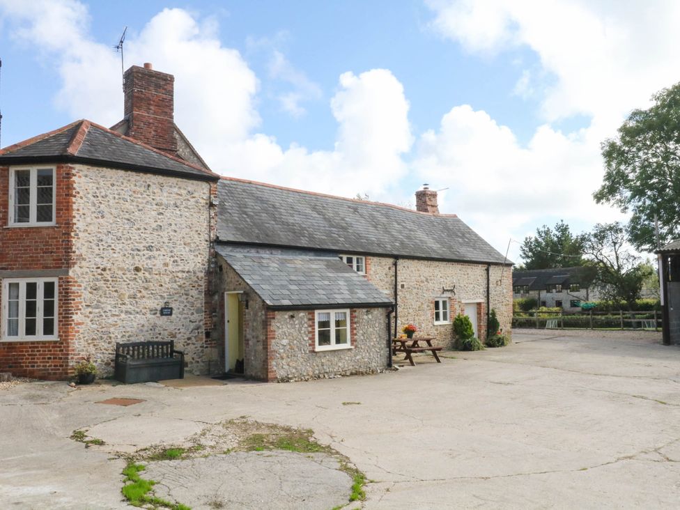 A house with a slate roof and outdoor seating area at The Cheese House near Charmouth