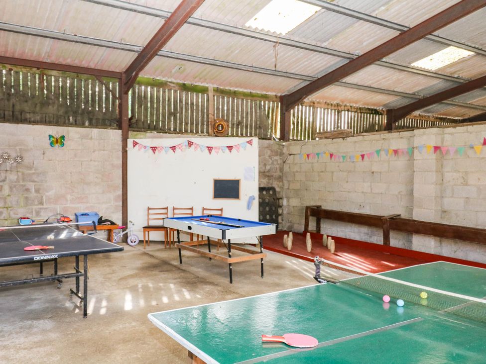An indoor recreation room with table tennis and pool tables at The Cheese House near Charmouth