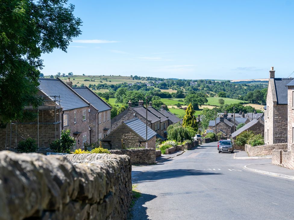 A street view of houses and fields at Birchover Chapel in Birchover