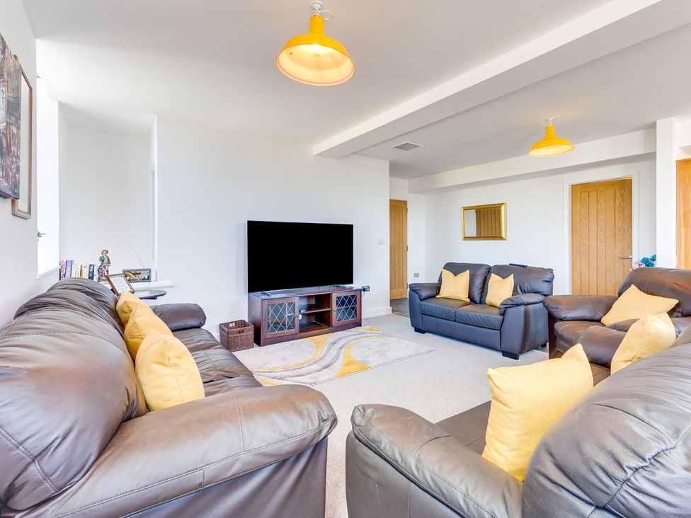 A living room with sofas and a television at Birchover Chapel in Birchover