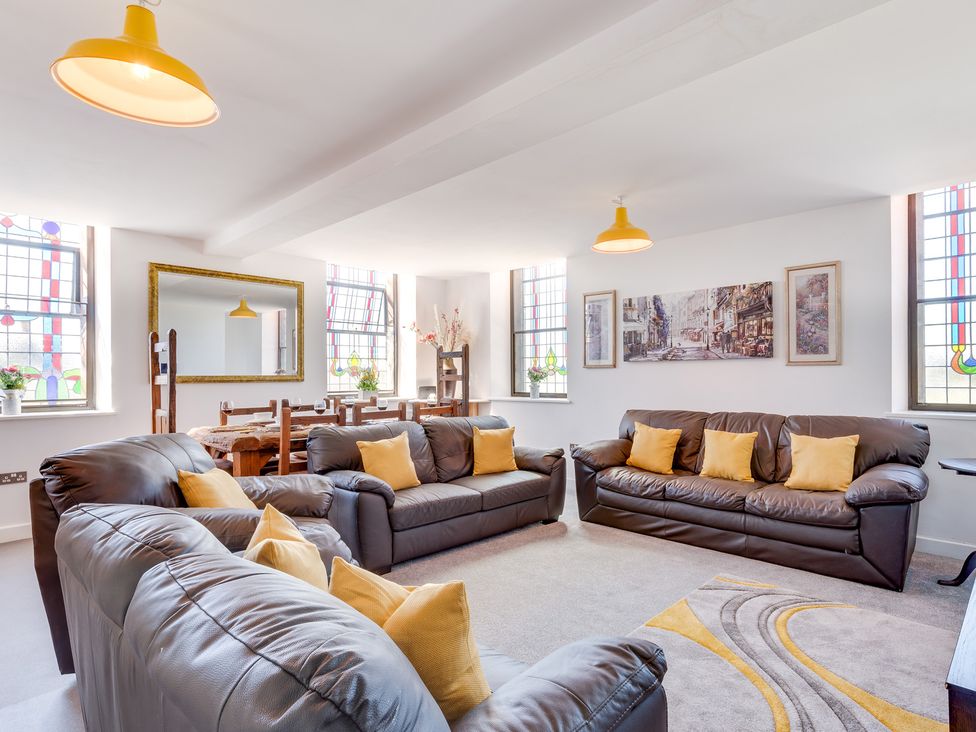 A living room with sofas and a dining table at Birchover Chapel in Birchover